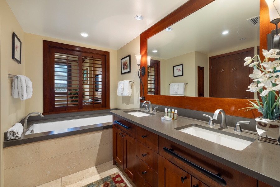 The primary guest bath features a luxurious soaking tub.