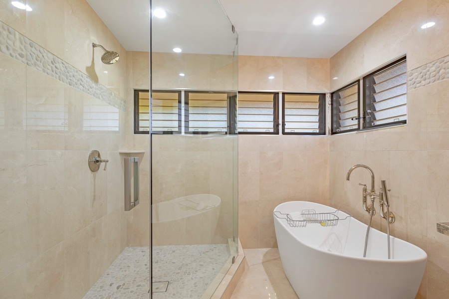 This spa-like bathroom features a sleek walk-in shower and a luxurious freestanding soaking tub