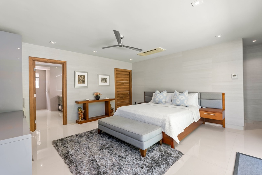 Drift off in this serene bedroom, where soft linens, modern style, and thoughtful touches create your peaceful retreat after a day of adventure.