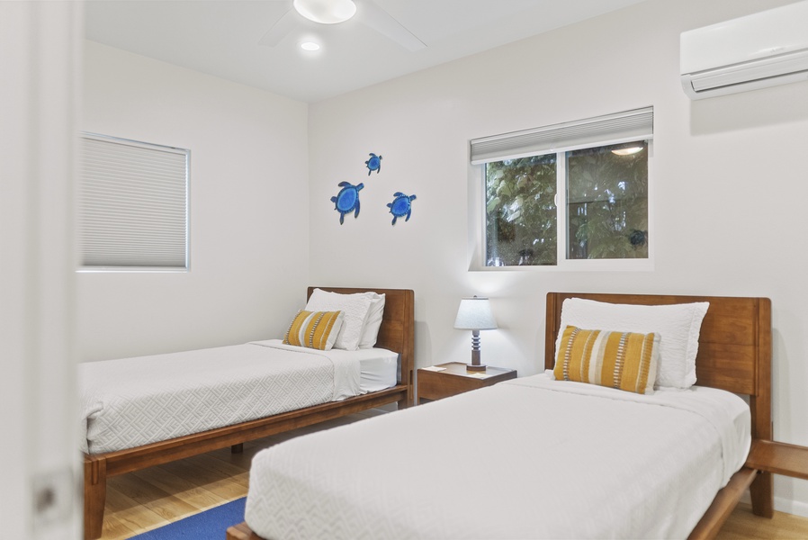 Bright twin bedroom with coastal accents—perfect for kids or friends, complete with A/C and plenty of natural light.