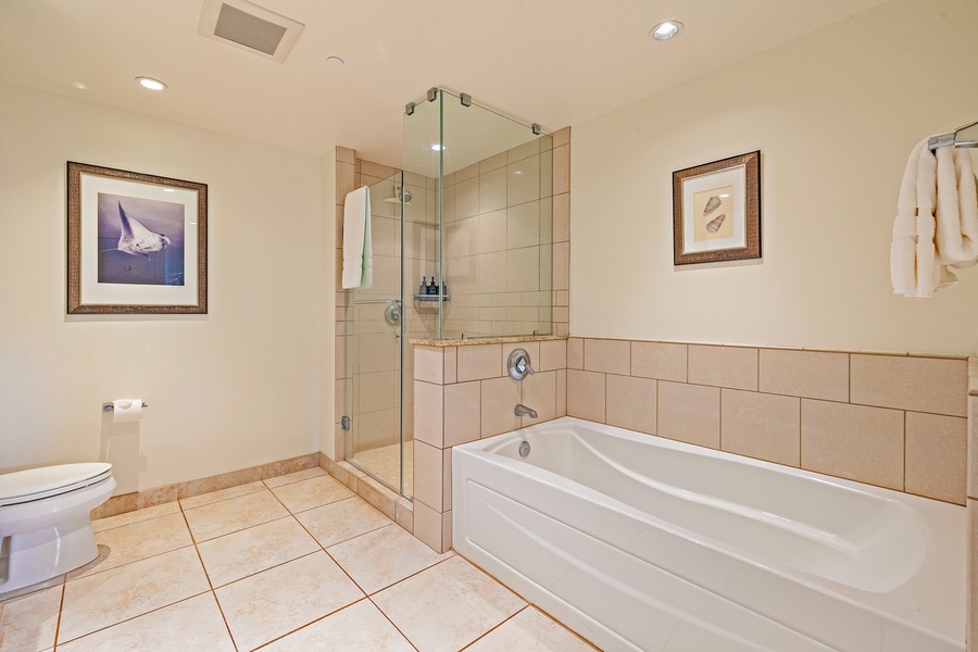 Enjoy a soaking tub and glass shower in Honua Kai Konea 206’s spa-style bathroom.