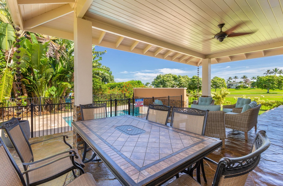Covered dining lanai at Pohaku Villa overlooking the pool — ideal for group meals in the shade.
