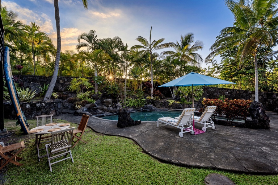 Your private tropical oasis awaits with a sparkling pool surrounded by swaying palms and comfortable lounge chairs for endless relaxation.