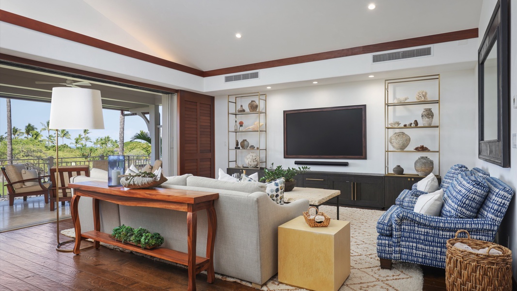 The living room offers a comfortable space with ample seating and a large TV, perfect for unwinding with loved ones.