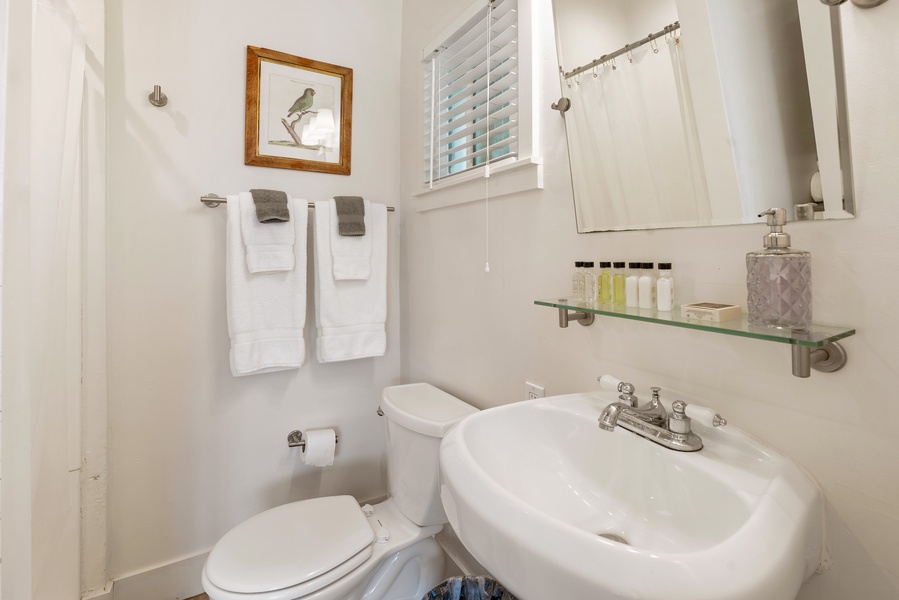 Stocked with essentials, this bright and tidy bathroom is perfect for refreshing after a day at the beach.