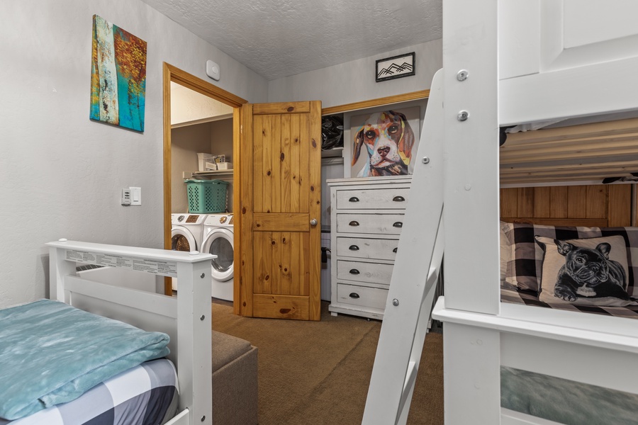 The third bedroom features two twin-over-twin bunk beds and a 40” flat-screen TV, making it an ideal space for kids or young adults