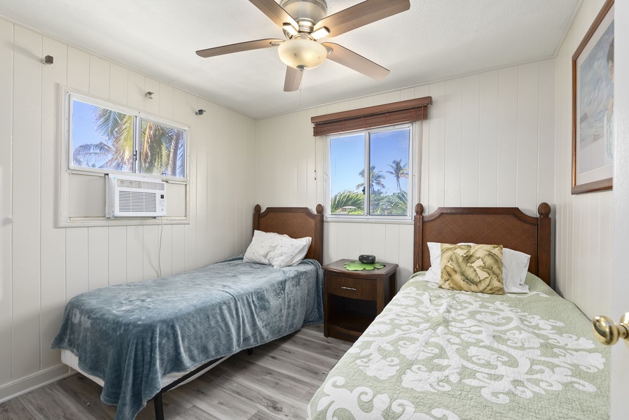 Alternate view of Guest Suite 2 at the Ohana Island Retreat with twin beds and bright natural light.