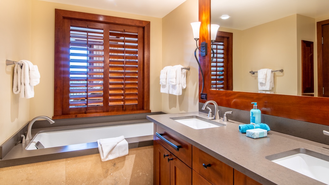 The primary guest bathroom has a walk-in shower and luxurious guest bath.