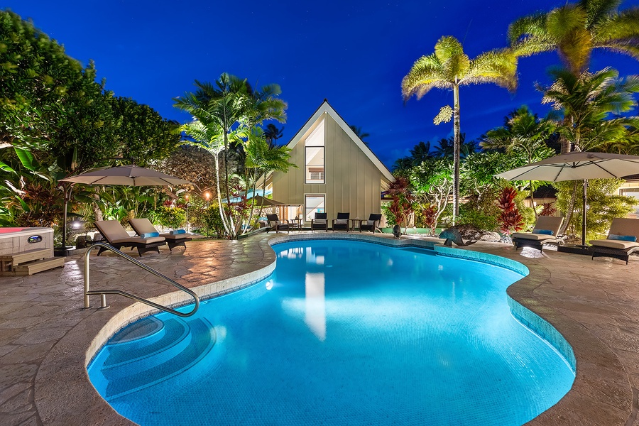 Sparkling pool surrounded by lush tropical landscaping, perfect for relaxation.