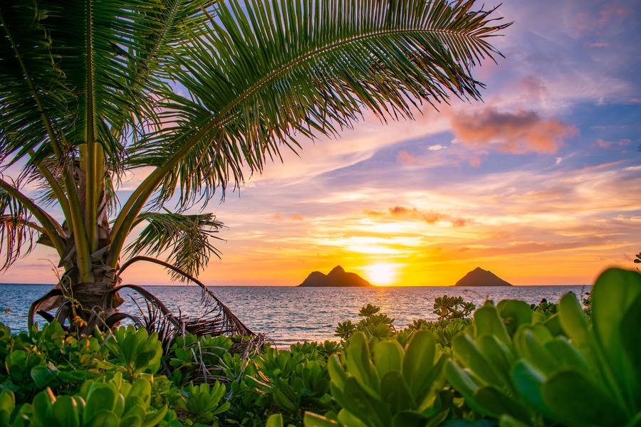 Sunset strolls on a tranquil Lanikai Beach with postcard-perfect Mokulua Islands scenery.