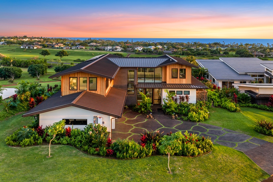 Your luxury home situated on pristine golf course with ocean views and tropical landscaping during golden hour.