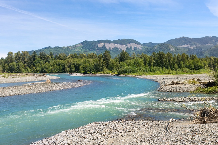 The serene allure of the Nooksack River nearby, a tranquil waterway offering peace and natural beauty at every bend.