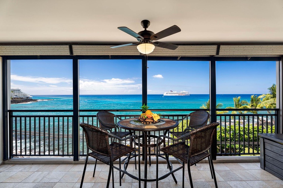 Cozy lanai set up for meals with a view of the Pacific.