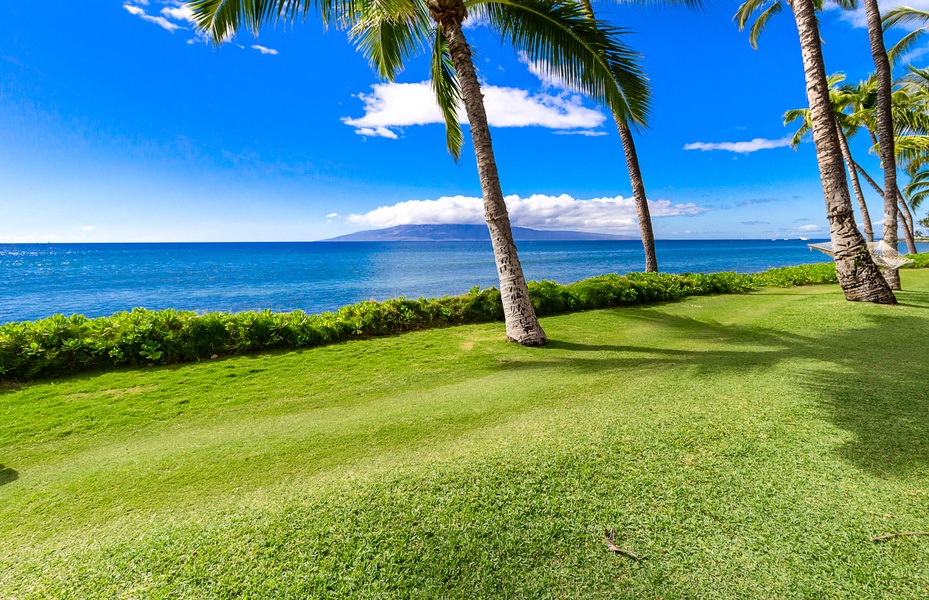 Indulge in luxurious relaxation on your private lanai, steps from the beach.