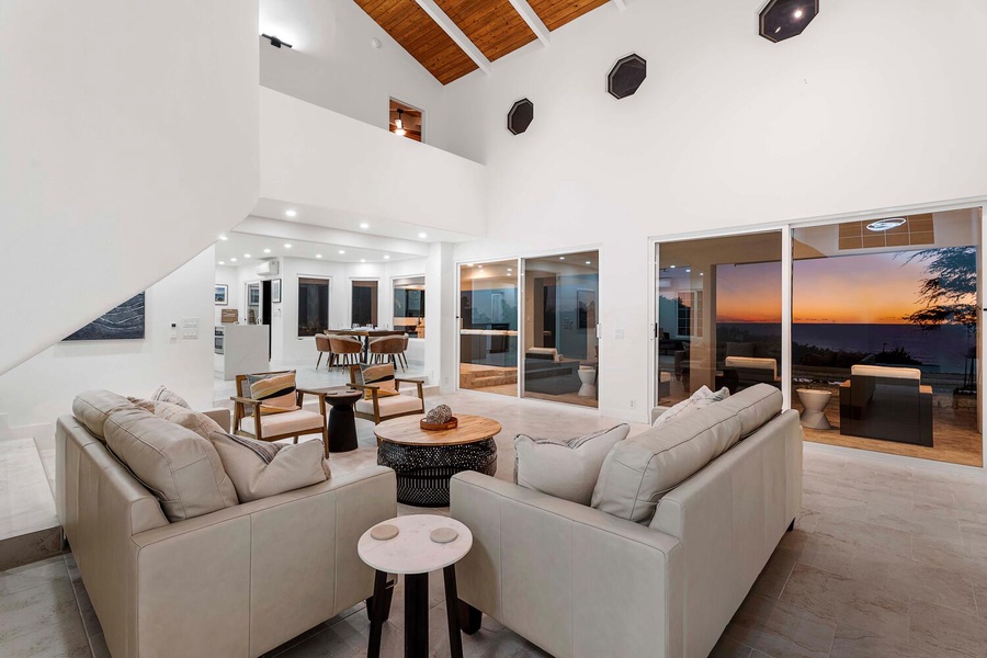Flounder in the spaciousness of the living area, highlighted by soaring vaulted ceilings and cozy sofas.