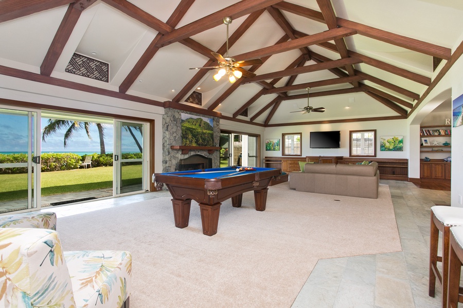 Play, relax, and entertain in a spacious game room that opens up to the beauty of the beachfront.