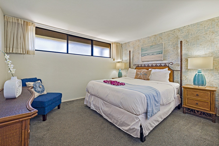 This serene bedroom offers a comfortable king-sized bed and calm decor, inviting you to unwind and recharge for another day in paradise.