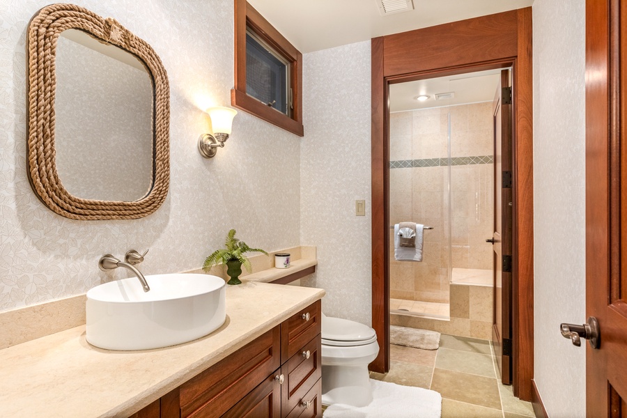 Elegantly designed full bath with walk-in shower, adjacent to the third guest bedroom.