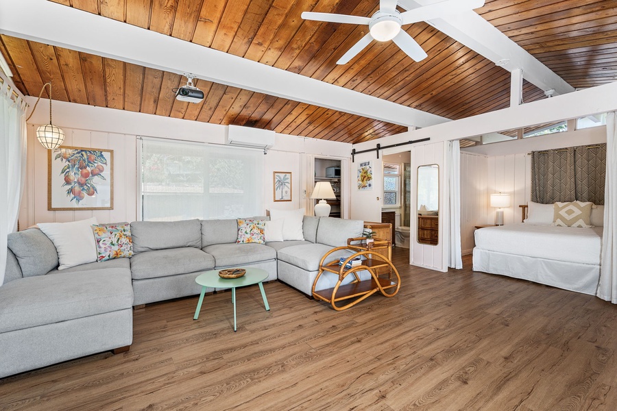 Unwind in your cozy open-plan Ohana with vaulted wood ceilings, plush sectional seating, and charming tropical touches.