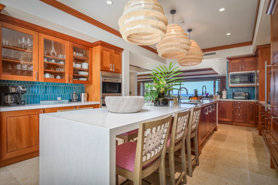 Spacious open concept kitchen with center island and bar seating.