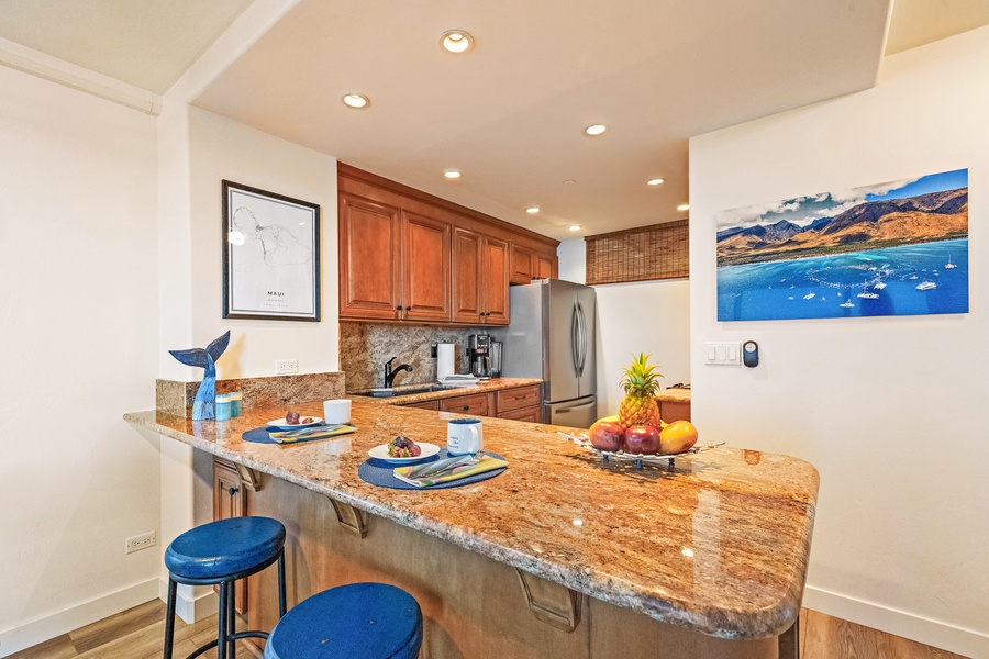 Granite-topped kitchen island at Mahana 1118 is perfect for prep or casual dining.