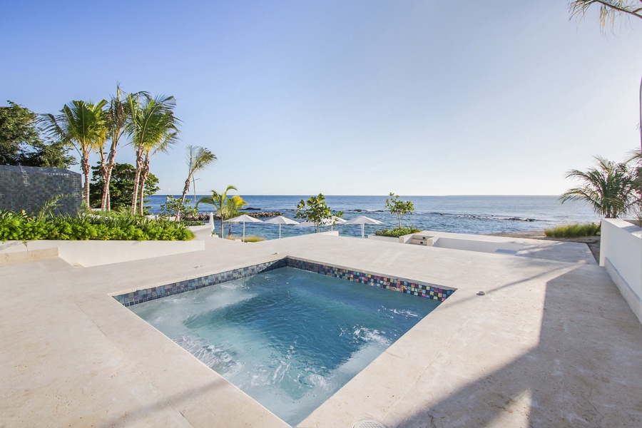 Relax in the oceanfront hot tub, surrounded by breathtaking views and lush tropical greenery at Villa Caleton.