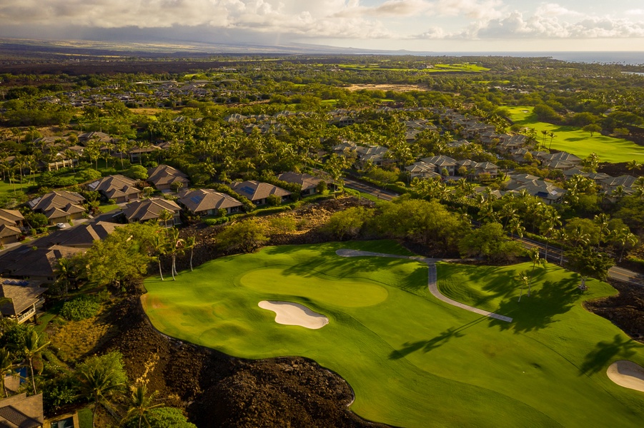 Home situated on Mauna Lani North Course 11th pin, tucked back into private tropical screening while not inhibiting the vista views from the home.