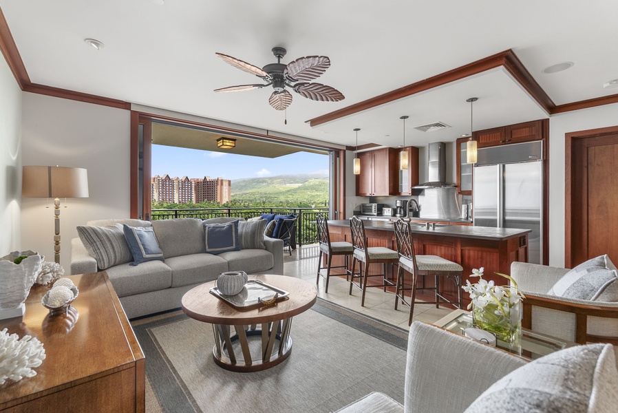 Unwind in your elegant open-plan living space where tropical ceiling fans and rich wood accents create island luxury.