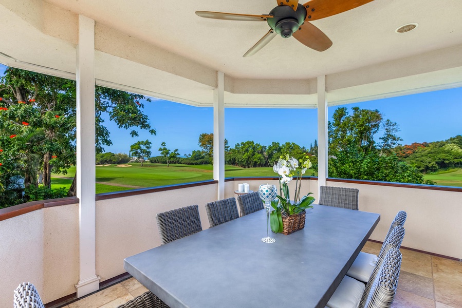Covered lanai with dining for eight, offering a shaded retreat and front-row views of the golf course and North Shore sunsets.