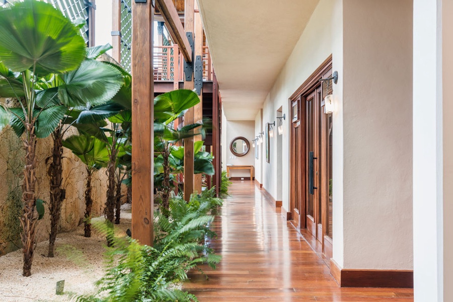 A tropical corridor leading to the tranquil spaces of the villa.