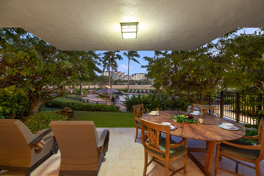 Lanai view with seating and loungers in a tropical paradise.