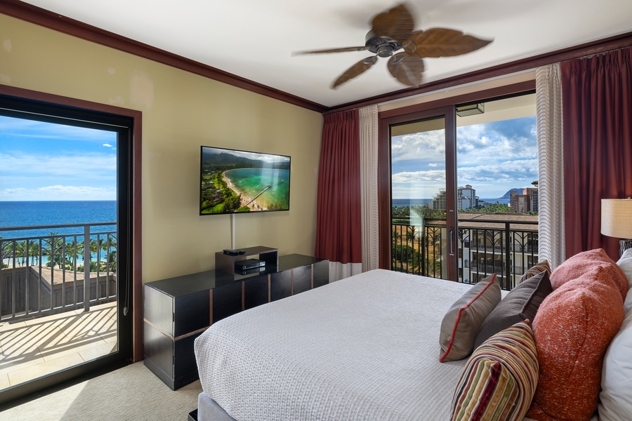 The primary guest bedroom features and king-sized bed, TV access to the private lanai.