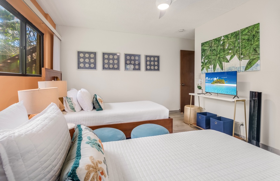 Drift off in your tropical twin beds with ocean-themed artwork creating a serene island escape.
