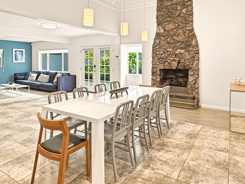 You'll love gathering around this spacious dining table with your group, warmed by the stunning stone fireplace.