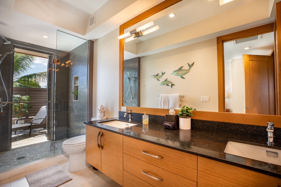 Luxury ensuite bathroom with two sinks and a wide vanity mirror