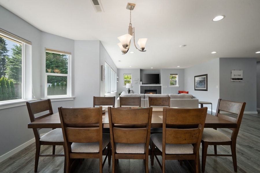 Large windows and an airy layout create a bright dining area perfect for family dinners or morning coffee before the beach.