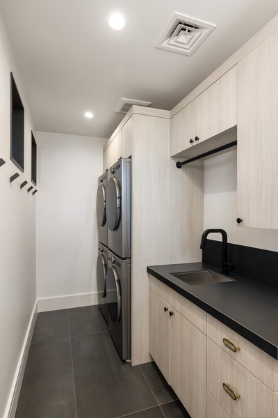 A convenient laundry room with premium appliances ensures comfort during longer stays at the estate.