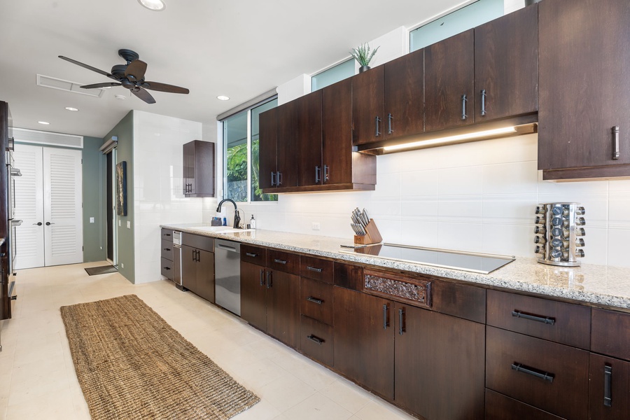Your gourmet kitchen features rich walnut cabinetry, granite counters, and stainless appliances perfect for creating memorable meals during your stay.
