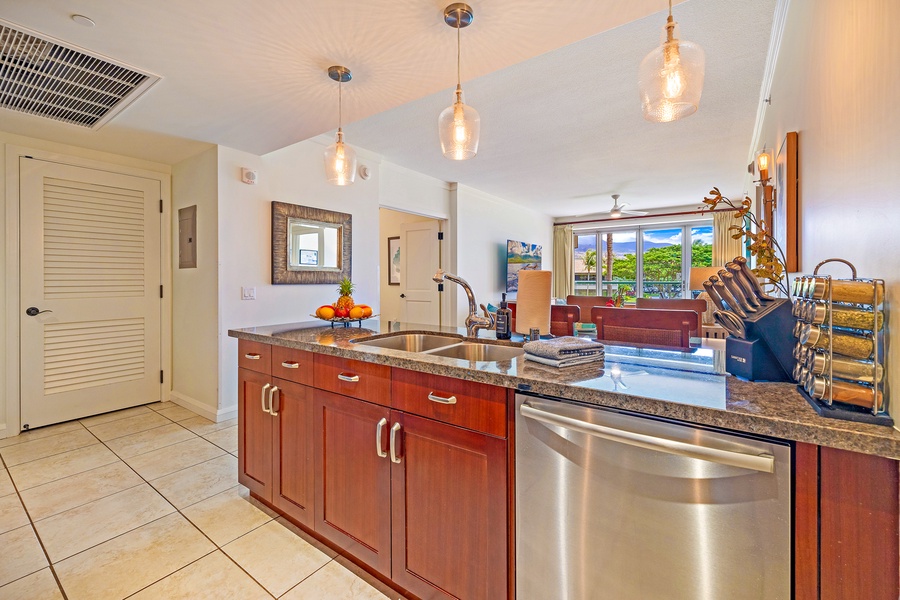 Modern kitchen at Honua Kai Konea 206 has stainless appliances and tropical views.