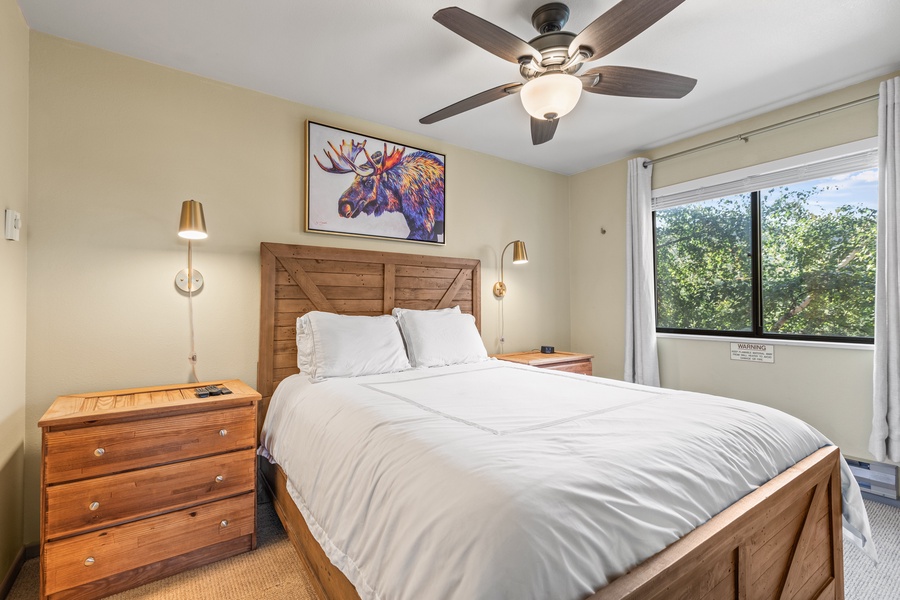 Drift into the primary suite, adorned with a full-size bed.
