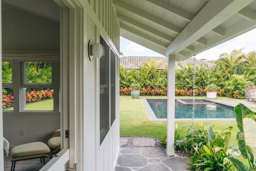 The covered lanai opens to tropical gardens and the private pool beyond.