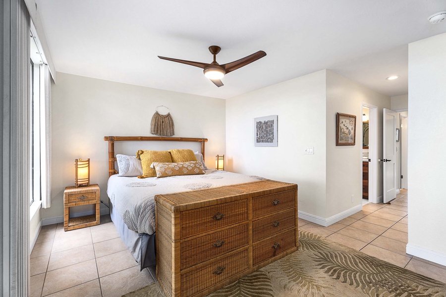 The bamboo bed frame on the King-size bed, the enchanting dresser and night tables, and all of the natural light give the room a tropical feel.