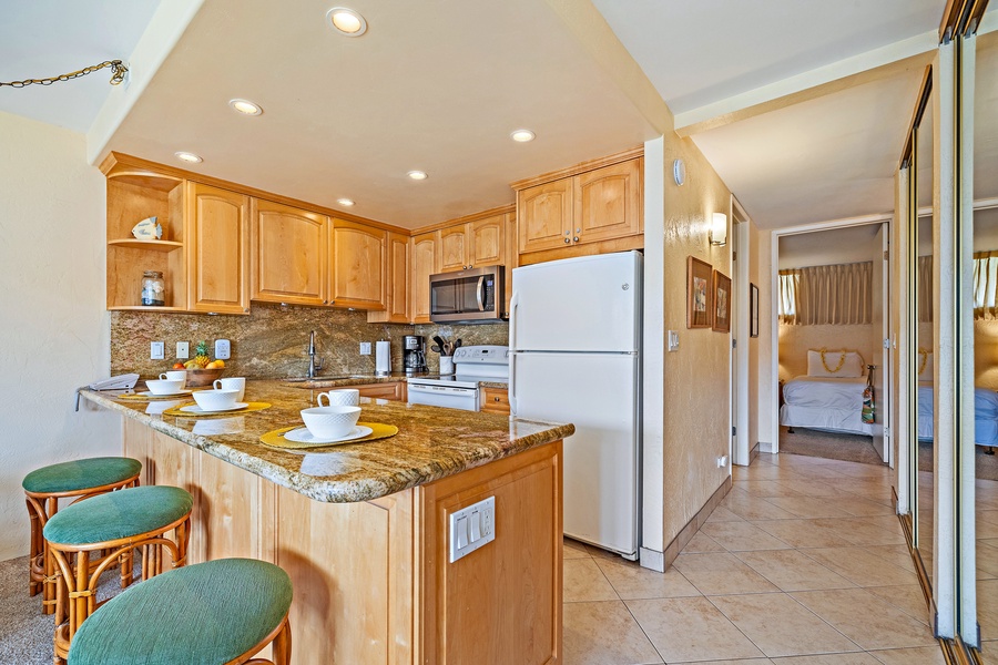 The fully equipped kitchen includes modern appliances and a breakfast bar, perfect for enjoying a quick meal or snack before heading out to explore.