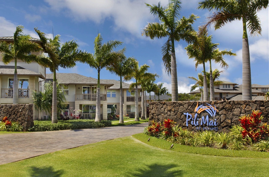 Welcoming entrance with beautiful landscaping and swaying palms.