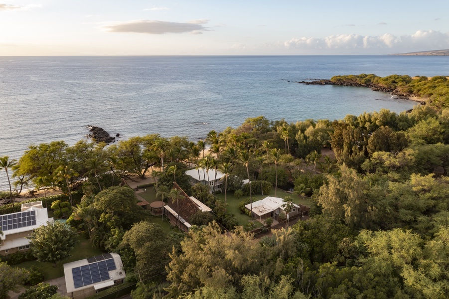 Aerial view of the property nestled along the coastline, showcasing breathtaking ocean views.