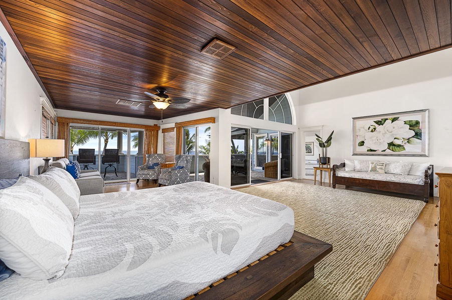 King bed in the primary suite with lanai access, central A/C, and flat-screen TV.