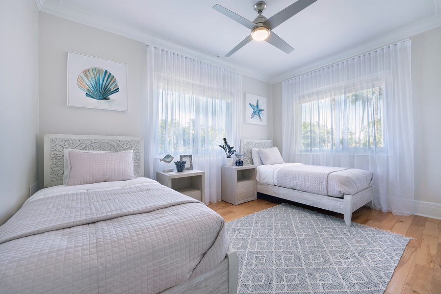 Guest bedroom with two twin beds, soft tones, and a tranquil vibe.