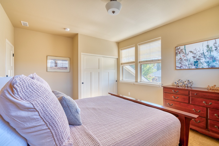 From the second bedroom, enjoy a pleasant view overlooking the yard, adding to the room's charm.