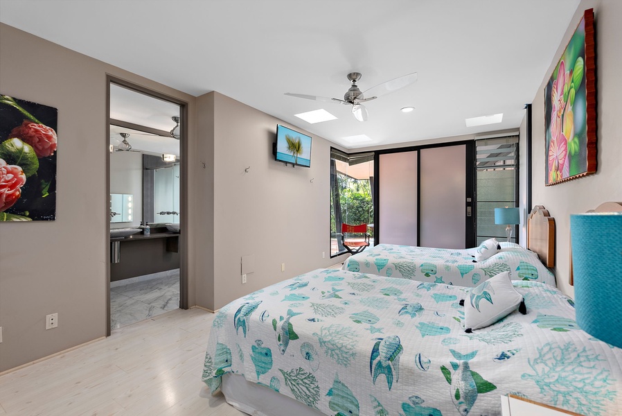 A bright and inviting bedroom with tropical touches and access to outdoor spaces.