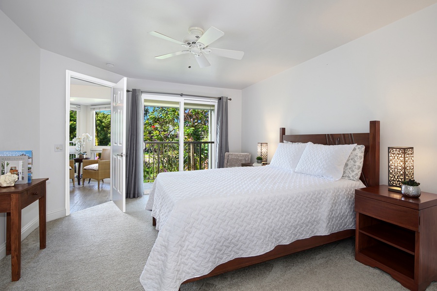 Downstairs primary suite features a king bed, seating area, and patio access.